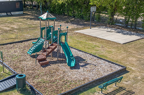 Playground and basketball court at Newark MHC, TX